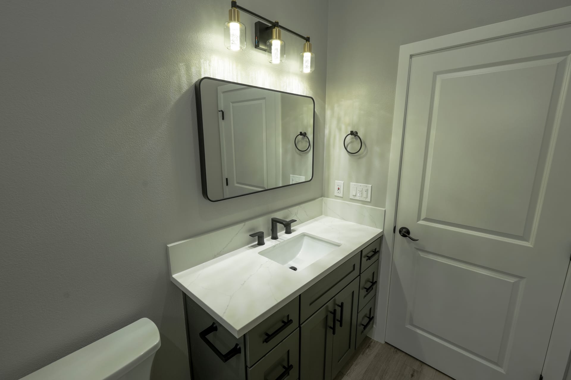 Bathroom vanity and mirror beside the shower