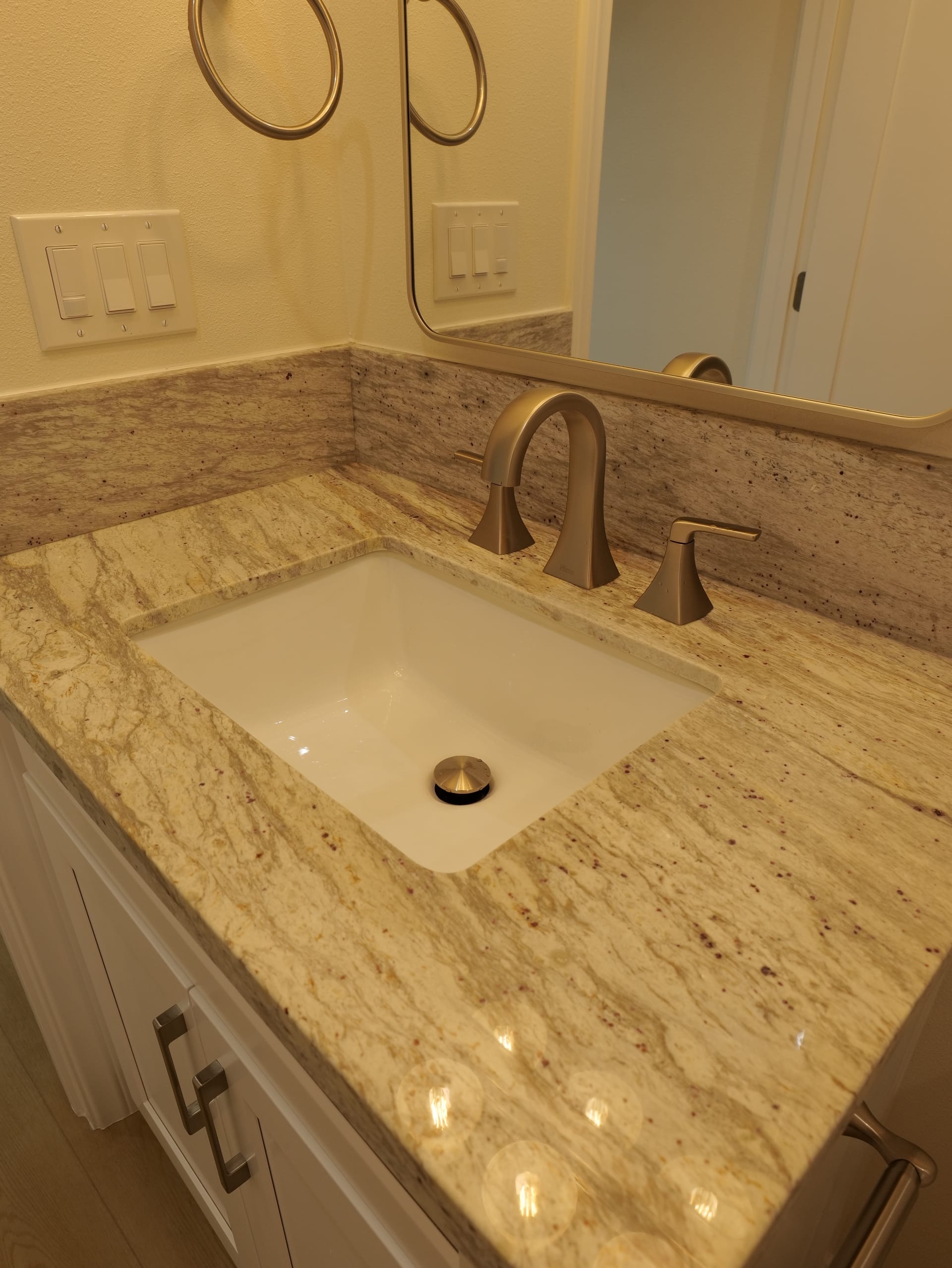 bathroom vanity with granite counter, single sink, and mirror