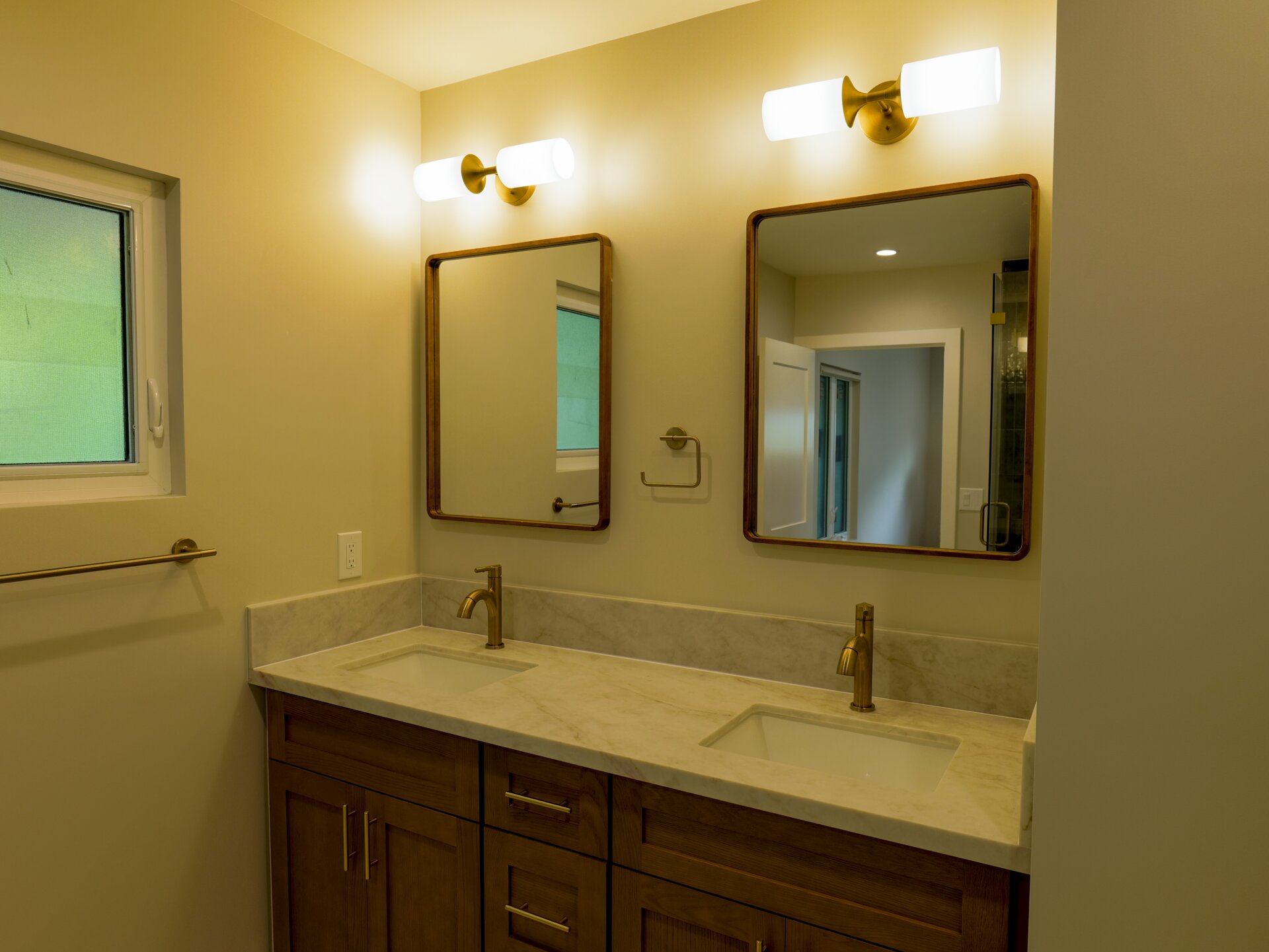 Wood double vanity with paired mirrors and sconces