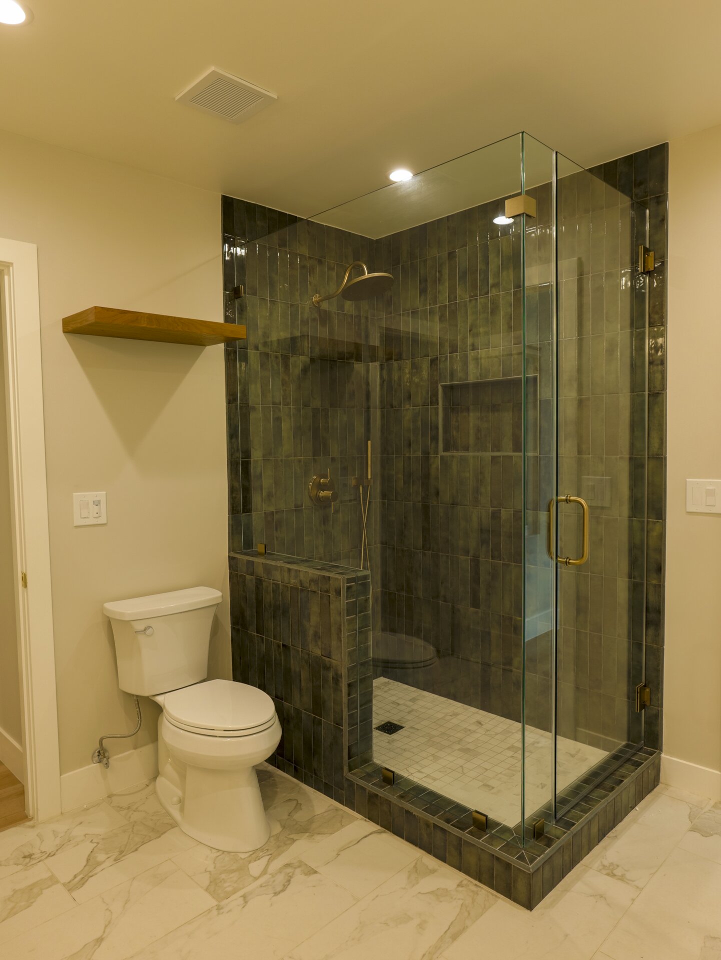 Stone shower enclosure with a built-in bench
