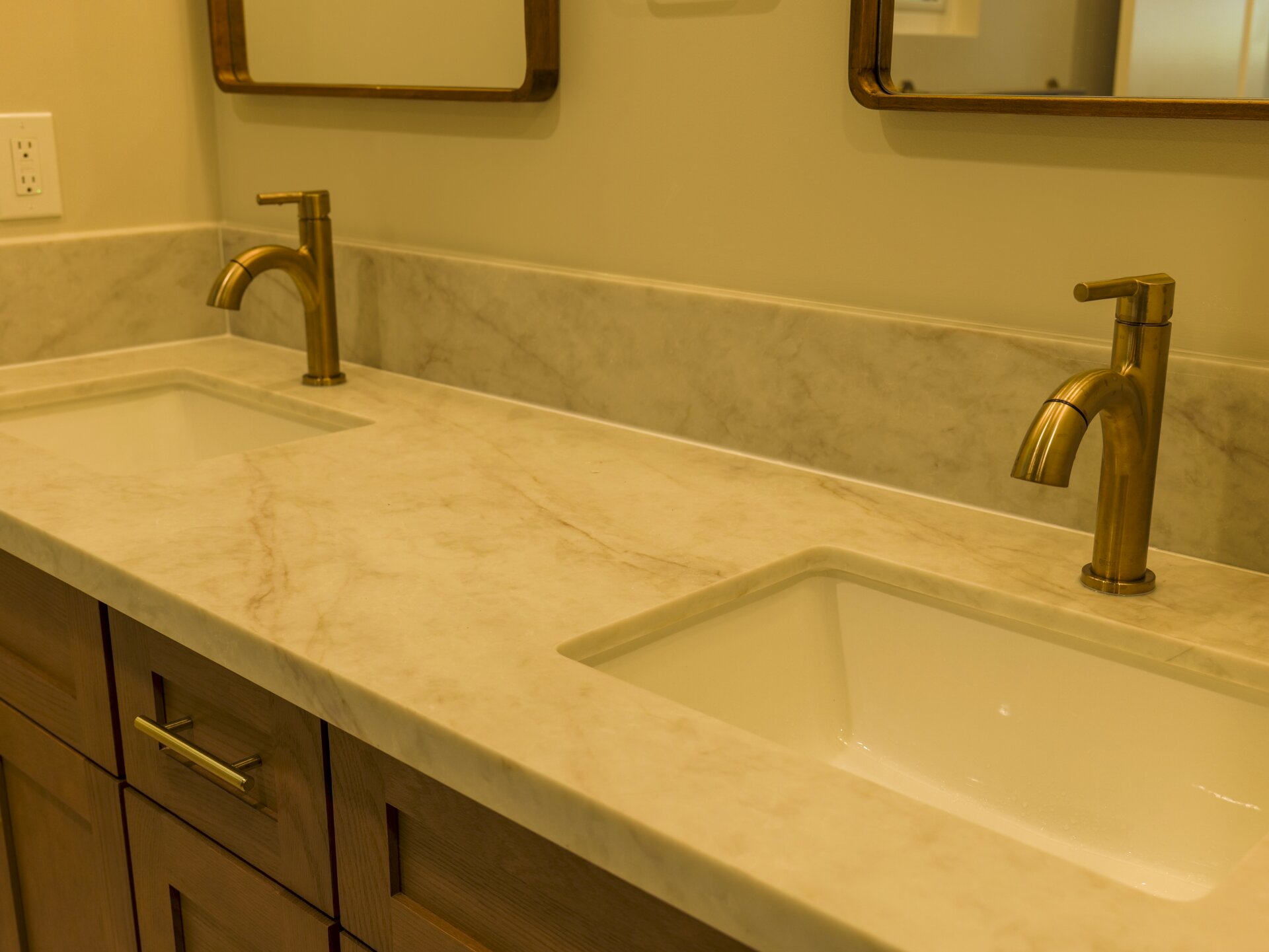 Double vanity countertop with warm metal faucets