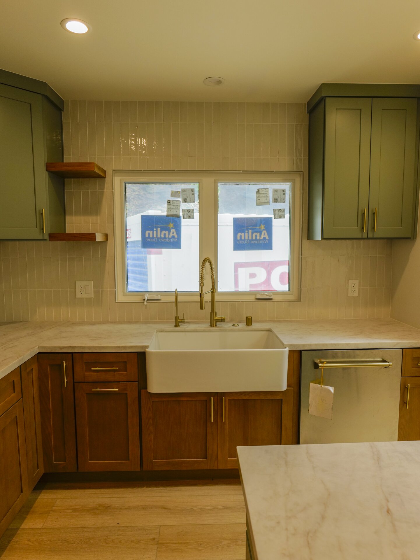 Wood kitchen cabinetry and sink beneath a window