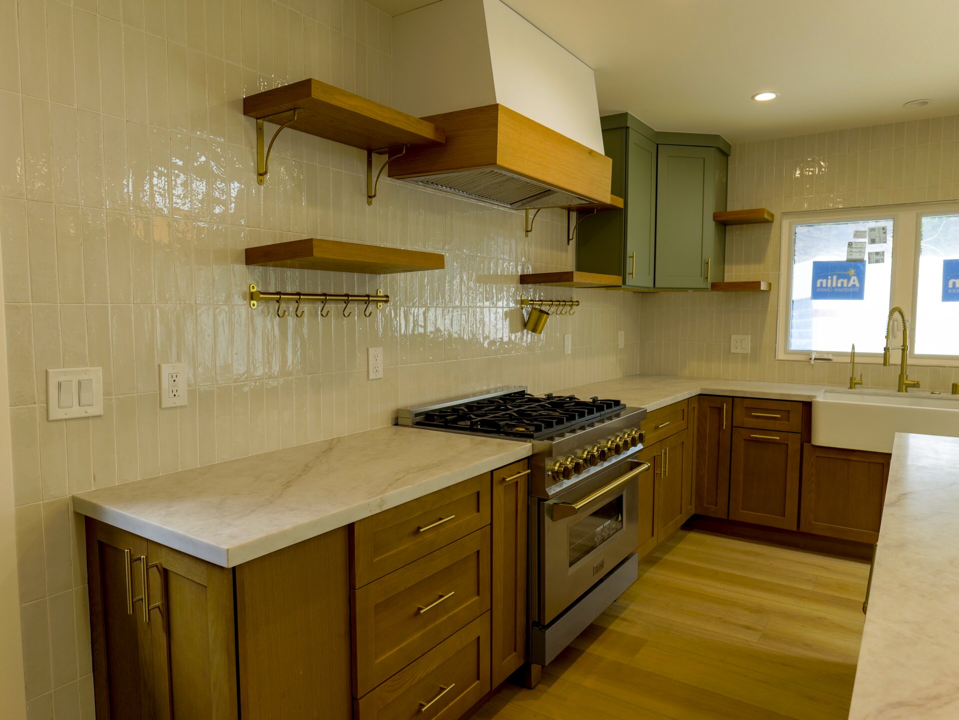 Wood kitchen cabinets with a broad work surface and green accents