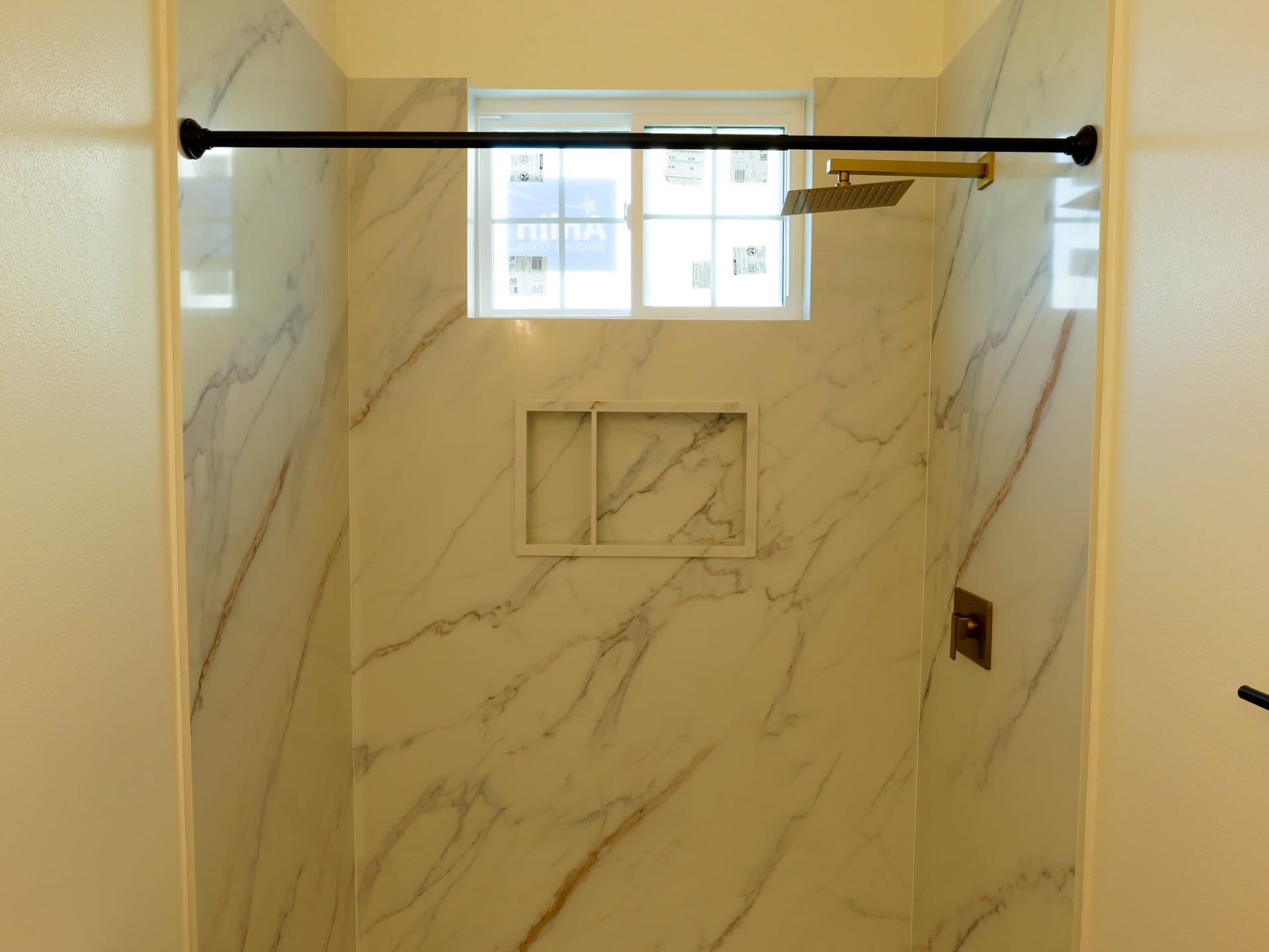 Warm-toned shower tile with a recessed storage niche