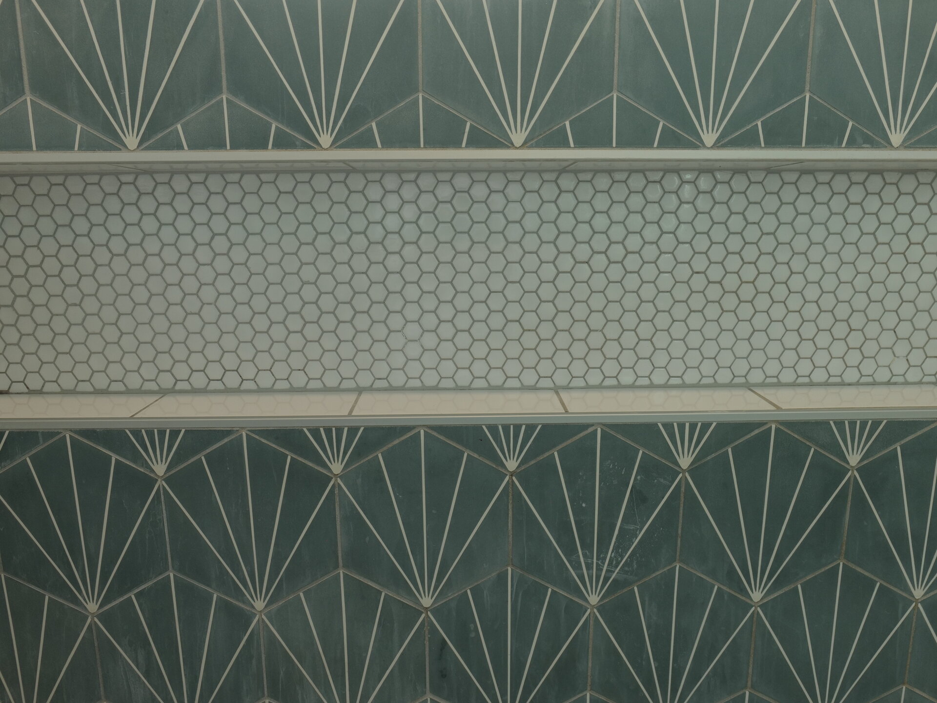 Green shower tile and recessed storage niche
